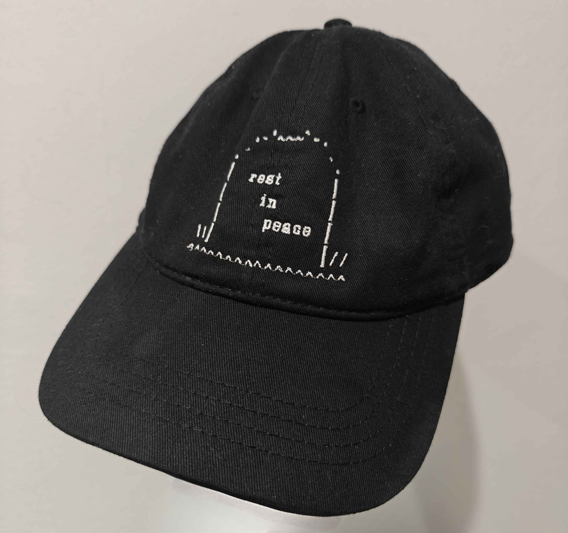 a hat with 'rest in peace' on it